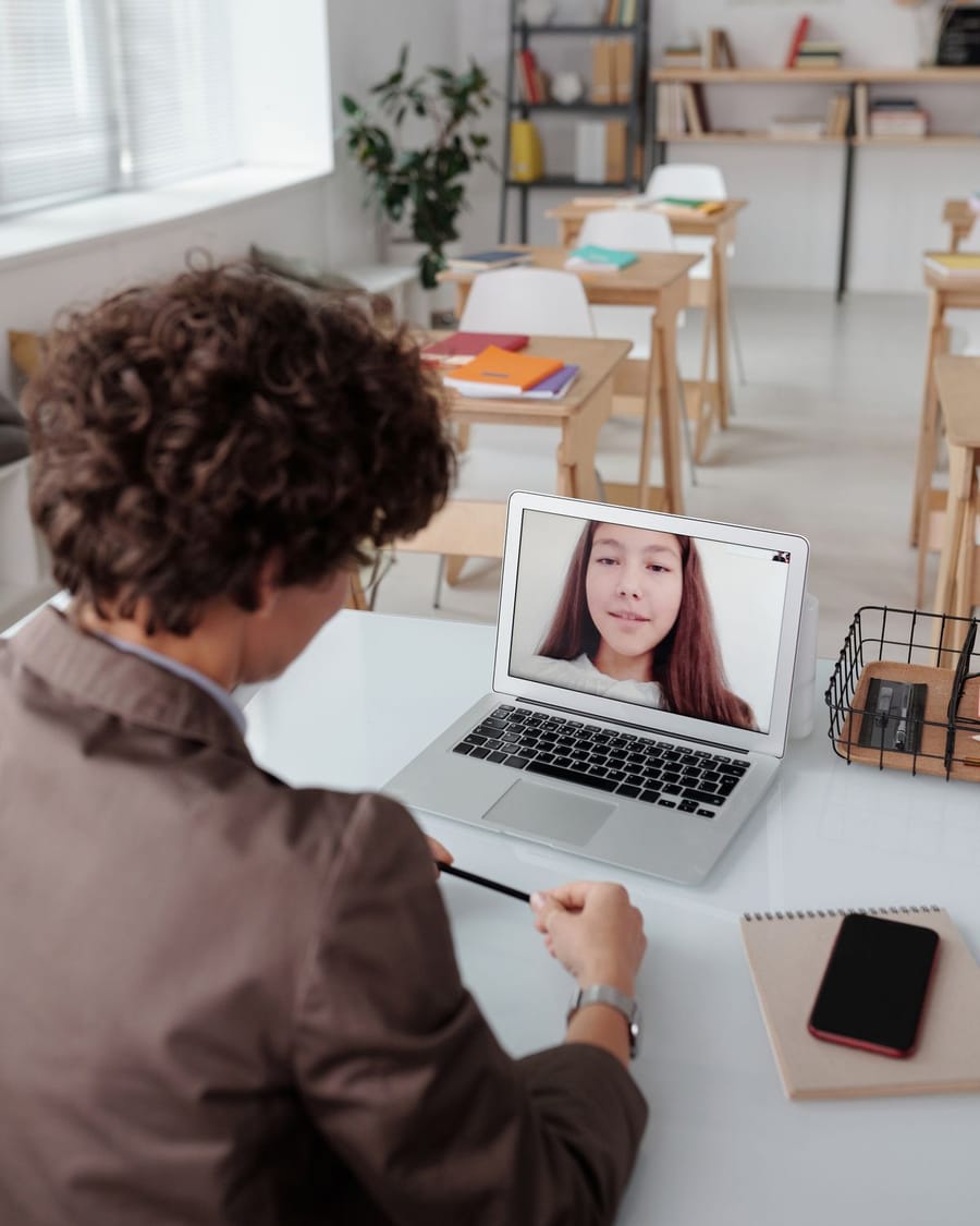 Teacher and student take part in a lesson by video call.